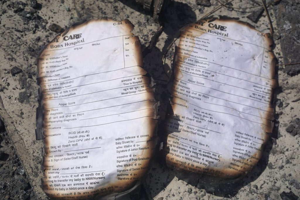 Burnt registration cards lie on the floor of a baby care centre in New Delhi after fire broke out on Saturday night, killing six infants. Photo: AP Burnt registration cards lie on the floor of a baby care centre in New Delhi after fire broke out on Saturday night, killing six infants. Photo: AP