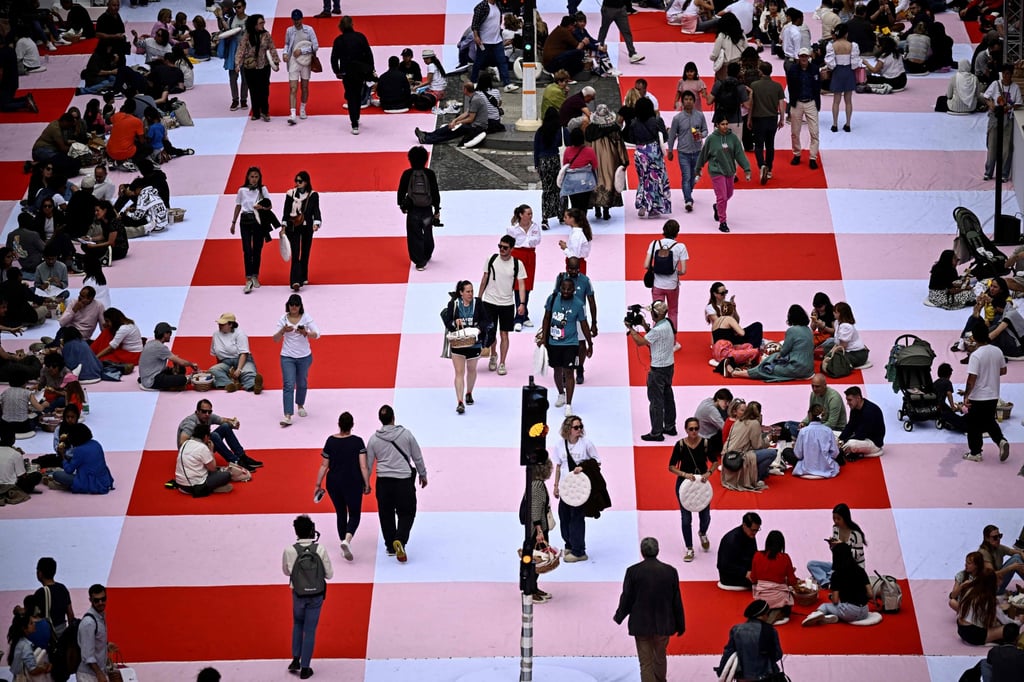 People take part in the giant open-air picnic. Photo: AFP