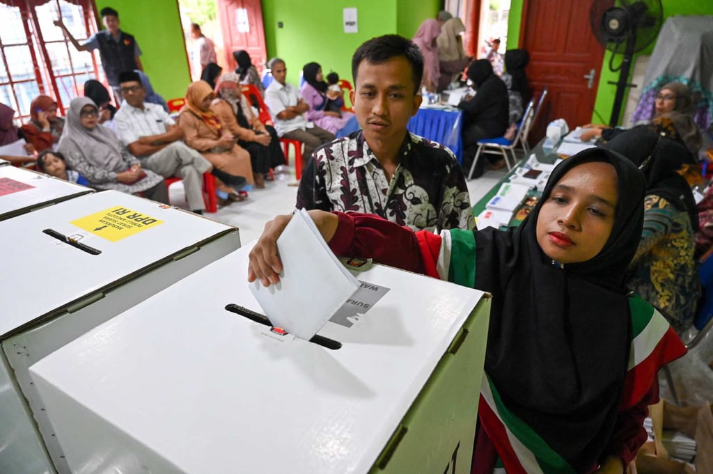 A woman casts her ballot for Indonesia’s presidential and legislative elections at a polling station in Banda Aceh on February 14. Photo: AFP A woman casts her ballot for Indonesia’s presidential and legislative elections at a polling station in Banda Aceh on February 14. Photo: AFP