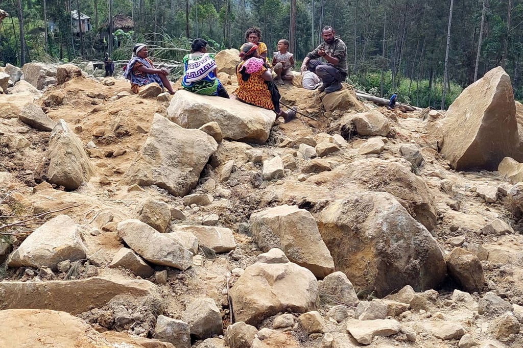 Family members of missing villagers are seen at the site of the landslide in Papua New Guinea’s Enga province on Sunday. Photo: AFP Family members of missing villagers are seen at the site of the landslide in Papua New Guinea’s Enga province on Sunday. Photo: AFP