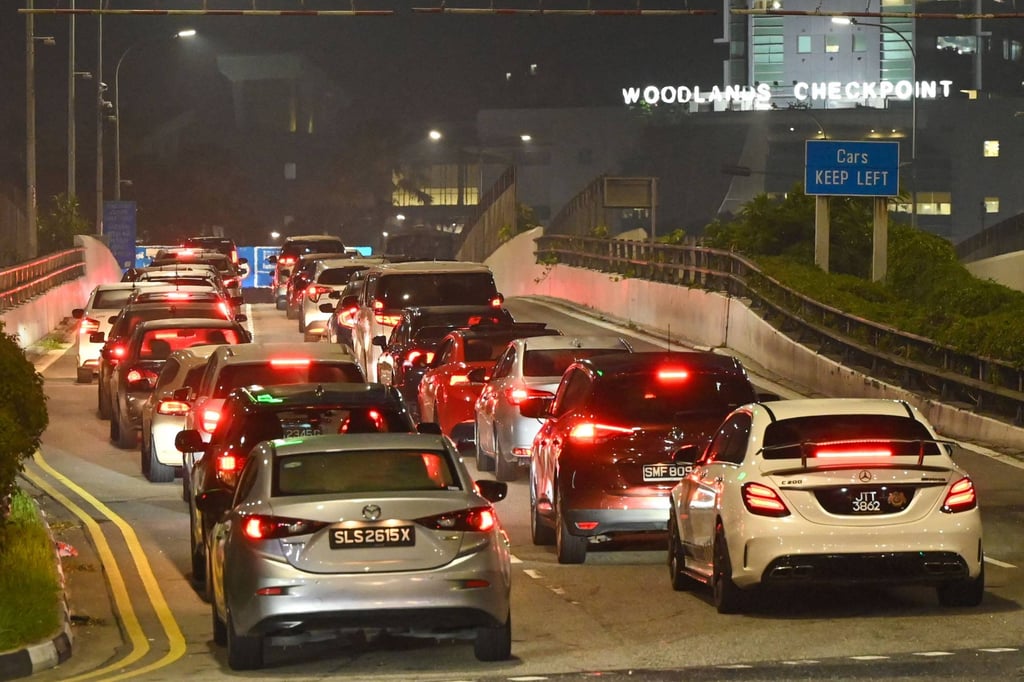 Vehicles queue to enter the Woodlands Checkpoint. Singapore-registered vehicles are required to pay a road charge of 20 ringgit to enter Malaysia via the Woodlands Causeway and Tuas Second Link checkpoints. Photo: AFP Vehicles queue to enter the Woodlands Checkpoint. Singapore-registered vehicles are required to pay a road charge of 20 ringgit to enter Malaysia via the Woodlands Causeway and Tuas Second Link checkpoints. Photo: AFP