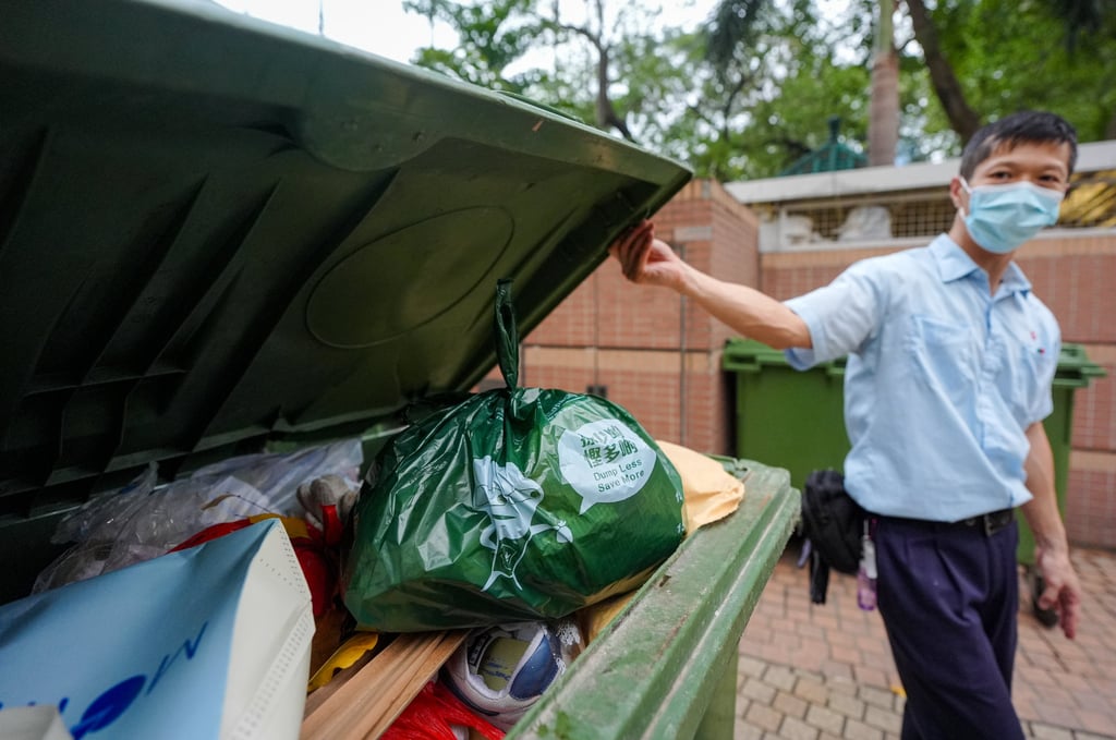 A resident disposes of a bag of garbage at a refuse collection point outside On Ning Lau, Moon Lok Dai Ha, in Tsuen Wan. Photo: Eugene Lee