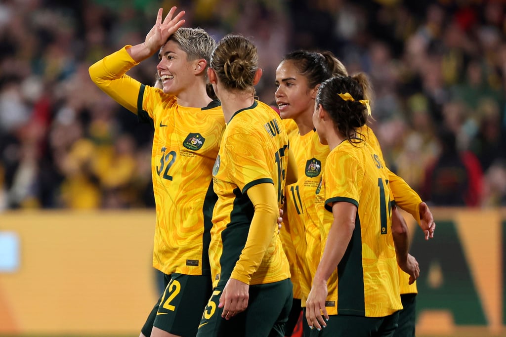 Australia’s Michelle Heyman, left, celebrates her late equaliser with her Australia teammates. Photo: AP