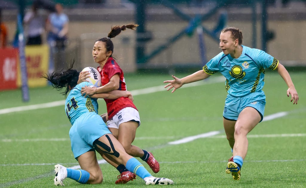 Hong Kong’s Chong Ka-yan is tackled by Kazakhstan’s Amina Tulegenpva (left) with teammate Anna Melnikova closing in. Photo: Jonathan Wong Hong Kong’s Chong Ka-yan is tackled by Kazakhstan’s Amina Tulegenpva (left) with teammate Anna Melnikova closing in. Photo: Jonathan Wong