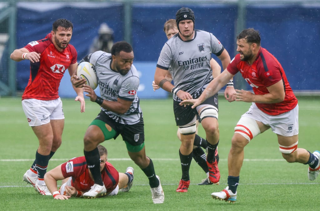 UAE’s Sakiusa Naisau breaks through the defence as Hong Kong captain Josh Hrstich (right) gives chase. Photo: Jonathan Wong
