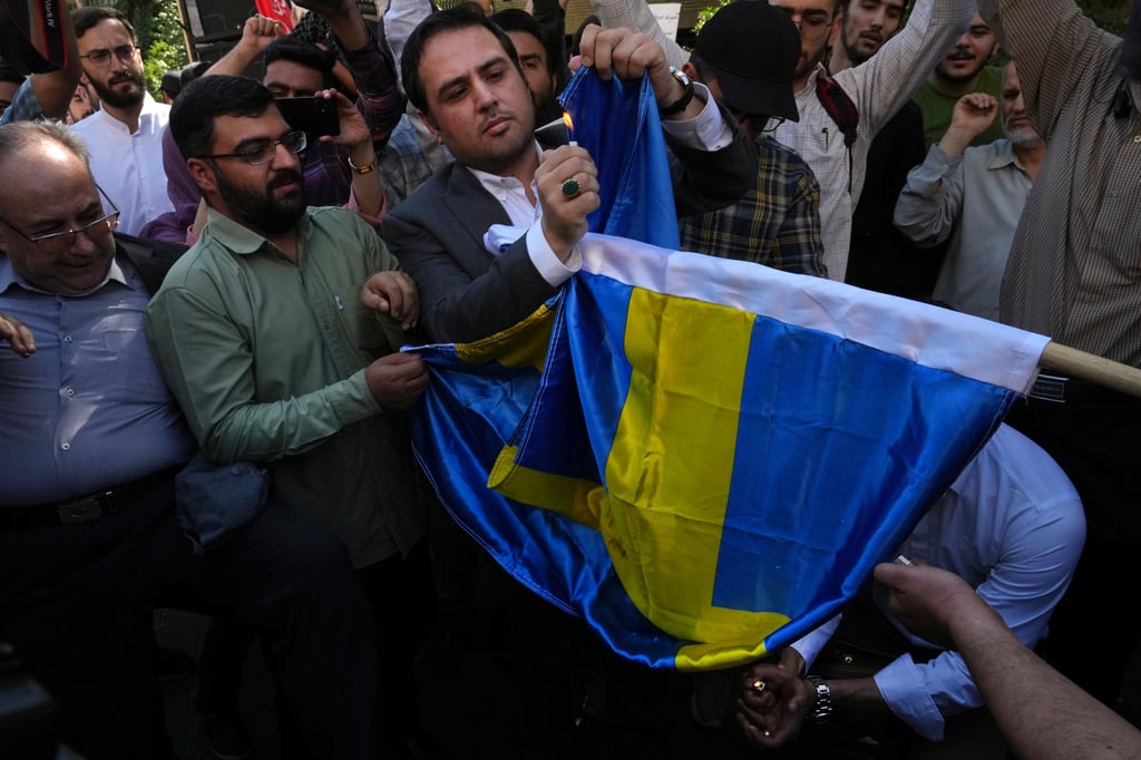 Protesters burn a Swedish flag in Tehran last year. Swedish intelligence has accused Iran of “using criminal networks in Sweden to carry out acts of violence”. Photo: AP