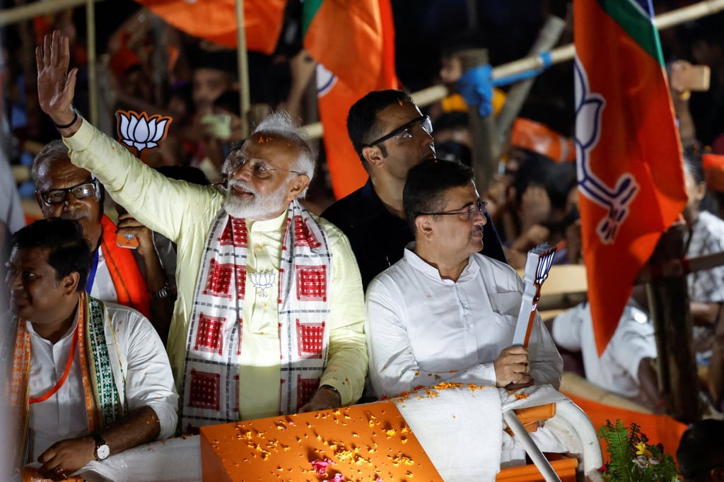 India’s Prime Minister Narendra Modi waves towards his supporters during a roadshow as part of an election campaign, in Kolkata. Photo: Reuters