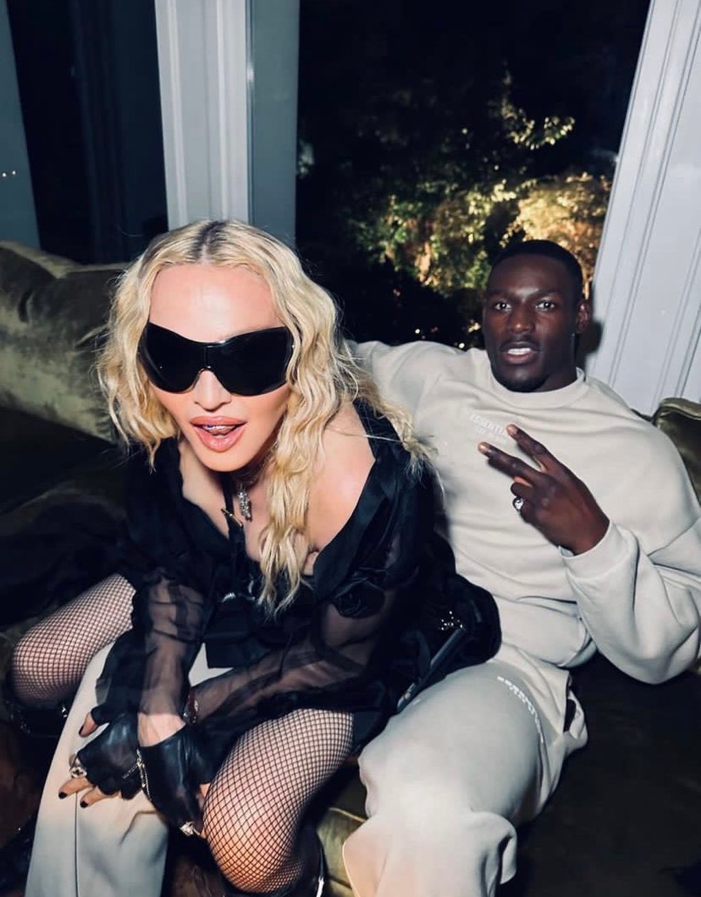 The photo of Madonna and Richard Riakporhe that set tongues wagging, which the pop icon captioned, “I had to sit somewhere” – before she deleted the post. Photo: @madonna/Instagram