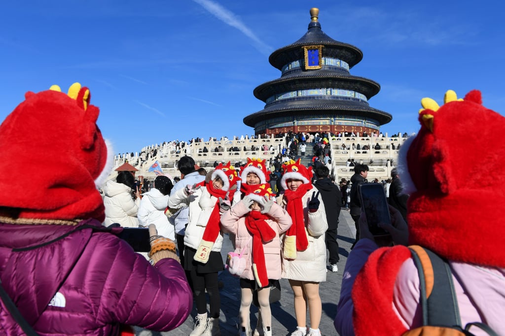Tourists from Malaysia pose for photos wearing dragon themed hats at the Temple of Heaven in Beijing, China, in January. Photo: Xinhua Tourists from Malaysia pose for photos wearing dragon themed hats at the Temple of Heaven in Beijing, China, in January. Photo: Xinhua