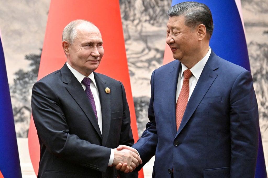 Russian President Vladimir Putin, left, shakes hands with Chinese President Xi Jinping in Beijing, China on May 16. Photo: Sputnik / Sergei Bobylev / Pool via Reuters