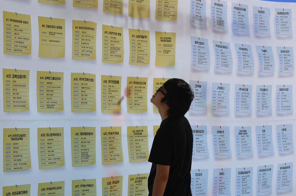 A jobseeker looks at notices while searching for employment at a jobs fair in South Korea. Photo: AFP A jobseeker looks at notices while searching for employment at a jobs fair in South Korea. Photo: AFP
