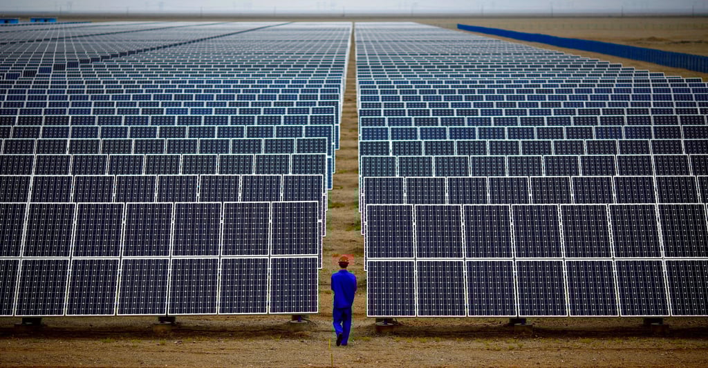 A worker inspects solar panels at Dunhuang, 950km northwest of Lanzhou, Gansu province. Photo: Reuters