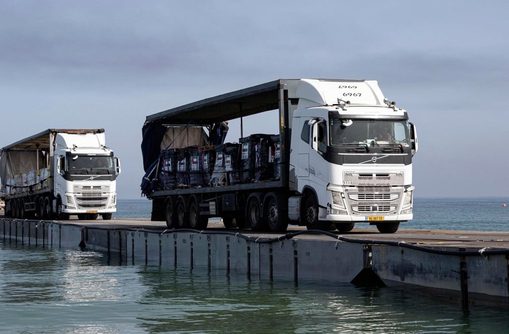 Trucks loaded with humanitarian aid from the UAE and the United States Agency for International Development cross the Trident Pier before arriving on the beach in the Gaza Strip on May 17. Photo: AP Trucks loaded with humanitarian aid from the UAE and the United States Agency for International Development cross the Trident Pier before arriving on the beach in the Gaza Strip on May 17. Photo: AP