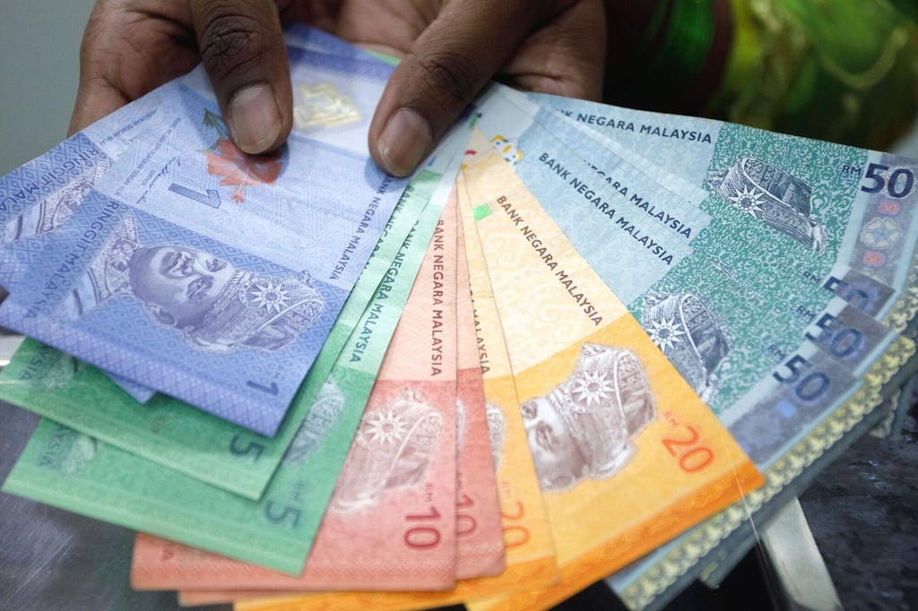 Malaysian ringgit banknotes. The government has offered a 200-ringgit monthly handout to some Malaysian to cushion the impact of the subsidy cut. Photo: Bloomberg Malaysian ringgit banknotes. The government has offered a 200-ringgit monthly handout to some Malaysian to cushion the impact of the subsidy cut. Photo: Bloomberg