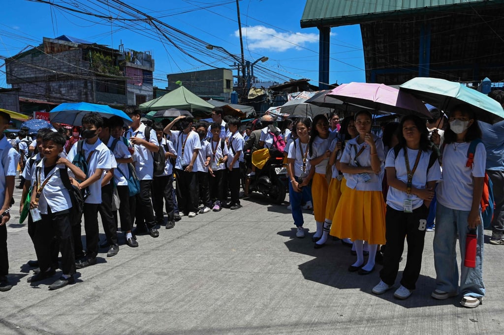 Students wait for their classes outside their school in Manila. The new pledge and hymn will be recited during weekly flag-raising ceremonies in schools and government agencies. Photo: AFP