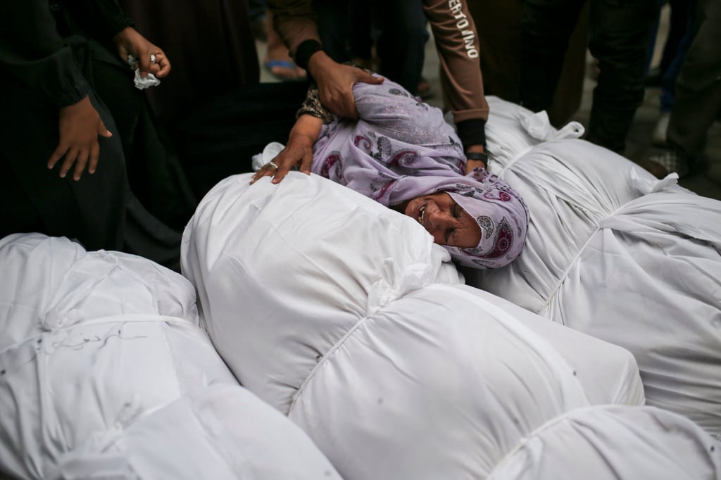 Palestinians mourn over the bodies of relatives killed in an Israeli air strike in Gaza. Photo: AP