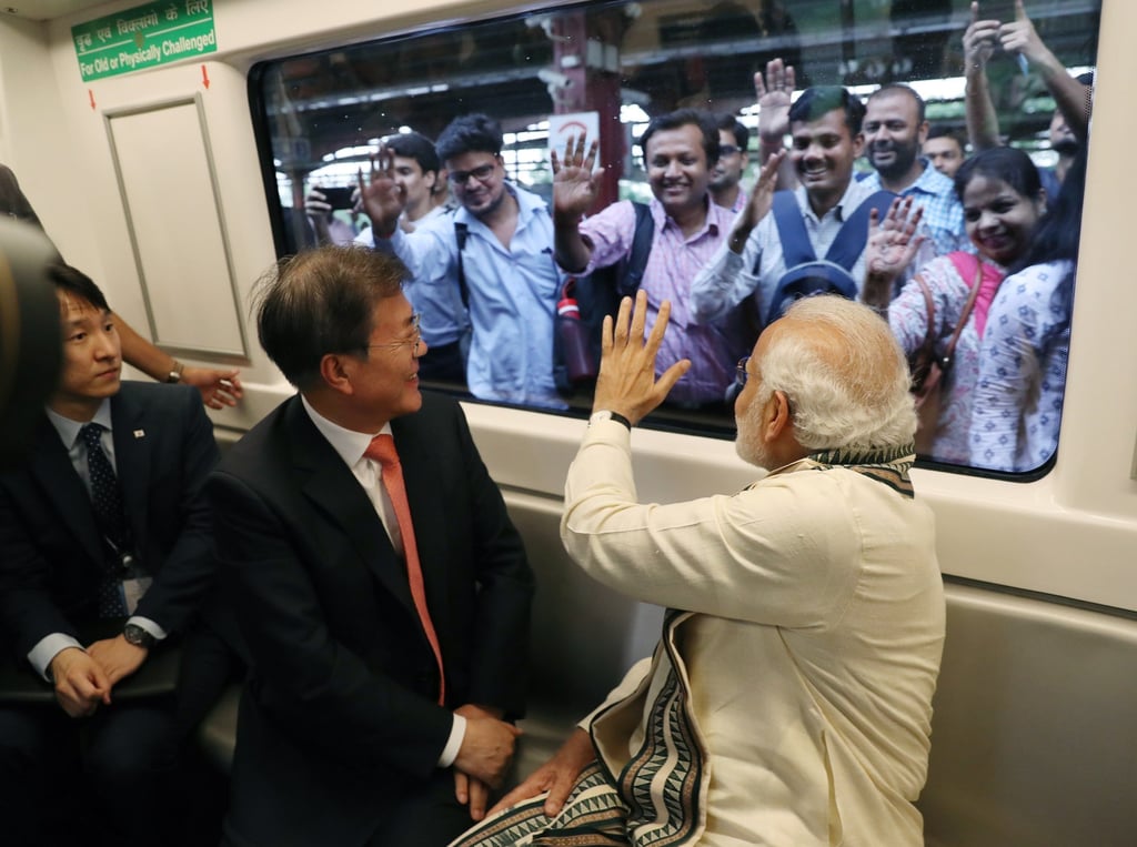 South Korean President Moon Jae-in (middle) and India’s Prime Minister Narendra Modi (right) ride a train to Samsung Electronics’ factory in northern India’s Uttar Pradesh, in 2018. Photo: EPA-EFE South Korean President Moon Jae-in (middle) and India’s Prime Minister Narendra Modi (right) ride a train to Samsung Electronics’ factory in northern India’s Uttar Pradesh, in 2018. Photo: EPA-EFE