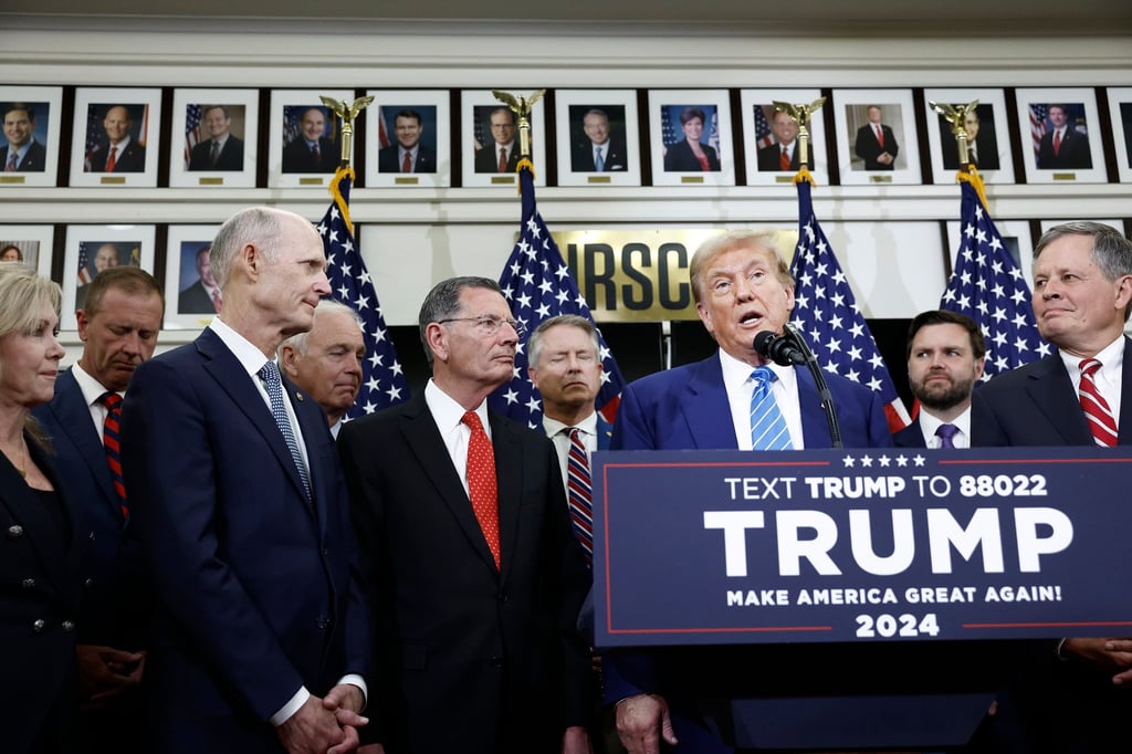 Donald Trump is flanked by Senate Republicans on Thursday. Photo: TNS