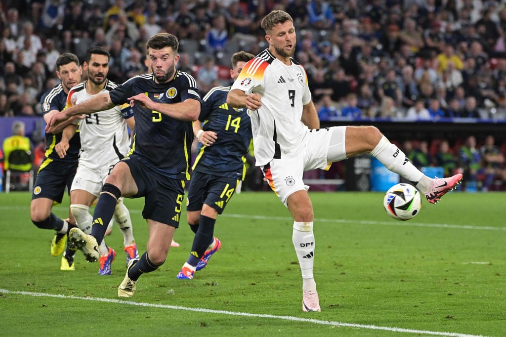 Germany’s Niclas Fullkrug fights for the ball with Scotland’s Grant Hanley during their Group A match. Photo: AFP