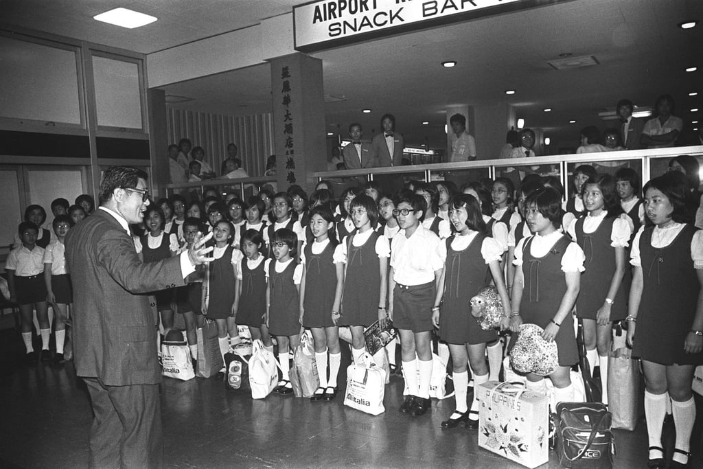 Yip Wai-hong conducts Hong Kong Children’s Choir members at Kai Tak Airport before their departure for the choir’s first European concert tour. Photo: SCMP