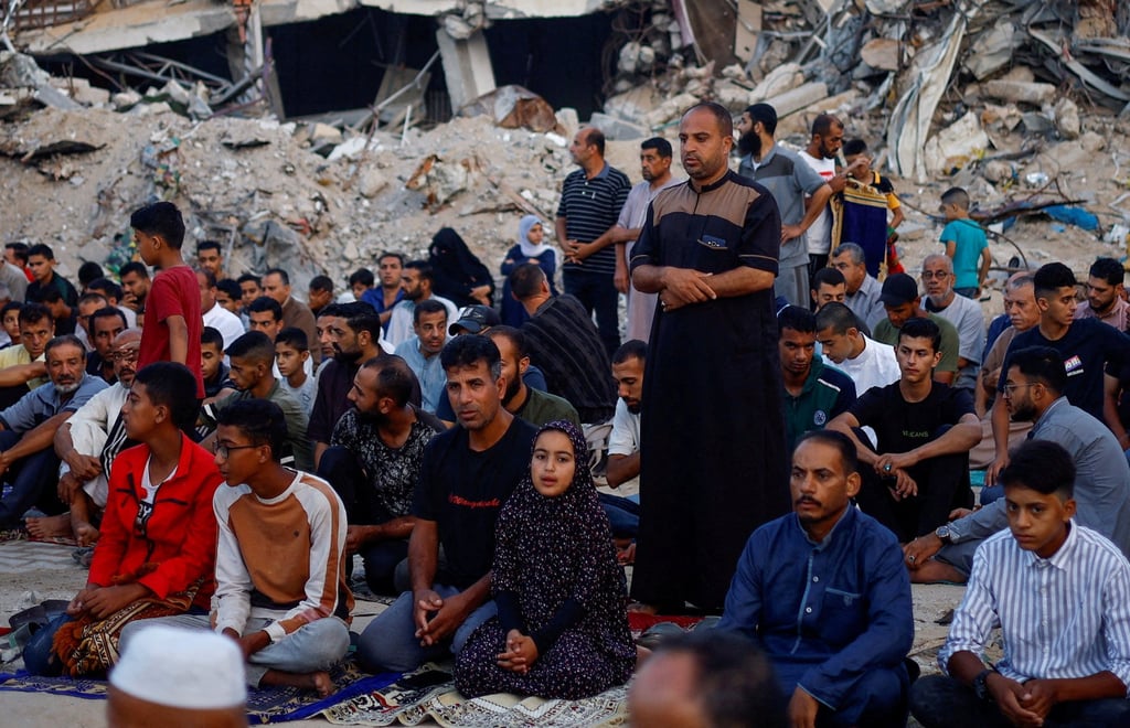 Palestinians hold Eid al-Adha prayers by the ruins of a mosque in Khan Younis, in the southern Gaza Strip. Photo: Reuters Palestinians hold Eid al-Adha prayers by the ruins of a mosque in Khan Younis, in the southern Gaza Strip. Photo: Reuters