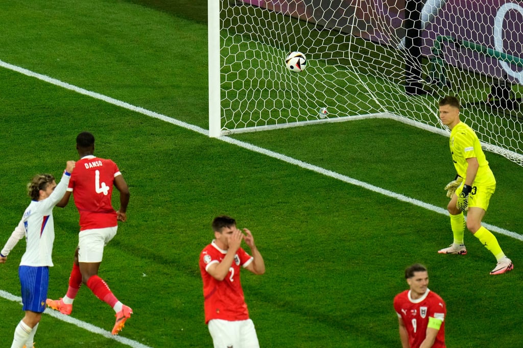 Austria’s goalkeeper Patrick Pentz, right, watches after Austria’s Maximilian Wober, centre, scored an own goal during a Group D match between Austria and France in Düsseldorf, Germany on Monday. Photo: AP