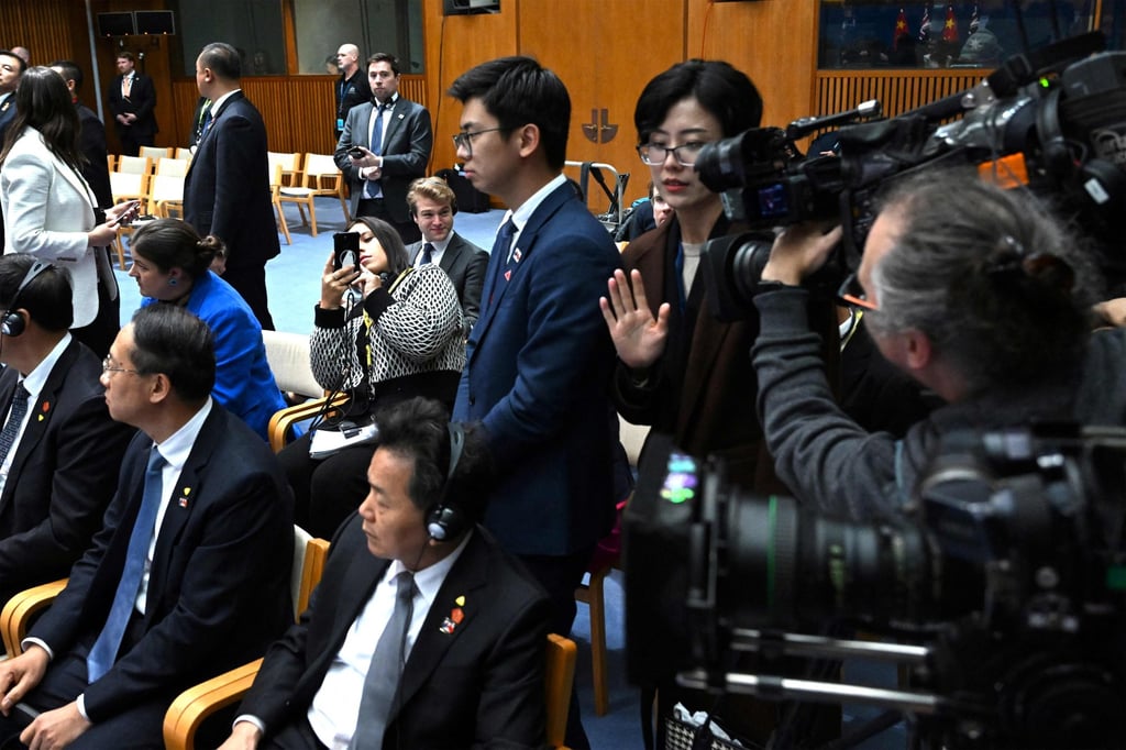 Chinese officials (centre left and right standing) stand next to Australian journalist Cheng Lei (obscured in frame) during a signing ceremony by China’s Premier Li Qiang and Australia’s Prime Minister Anthony Albanese on Monday. Photo: AFP/Pool