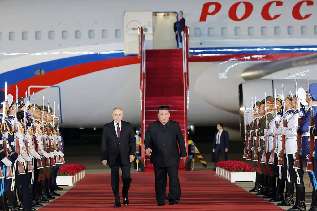 Kim and Putin walk past an honour guard at Sunan International Airport in Pyongyang on Wednesday. Photo: KCNA via KNS/AFP Kim and Putin walk past an honour guard at Sunan International Airport in Pyongyang on Wednesday. Photo: KCNA via KNS/AFP