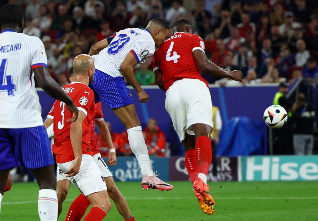 Kylian Mbappe broke his nose in this collision with Austrian defender Kevin Danso. Photo: Reuters