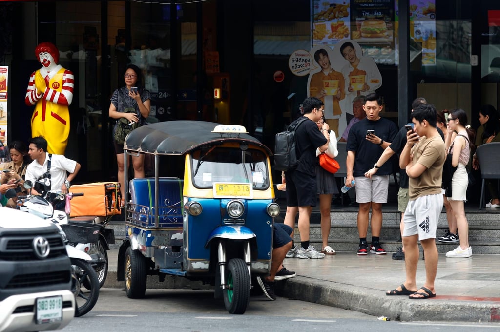 Tourists gather in front of a shopping centre in Bangkok. Photo: EPA-EFE