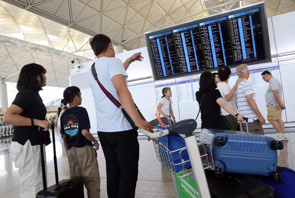 Travellers check the flight display screen at the Departure Hall in Hong Kong International Airport. A cargo plane’s emergency landing closed the airport’s north runway for more than 8 hours and affected about 450 flights. Photo: Jelly Tse
