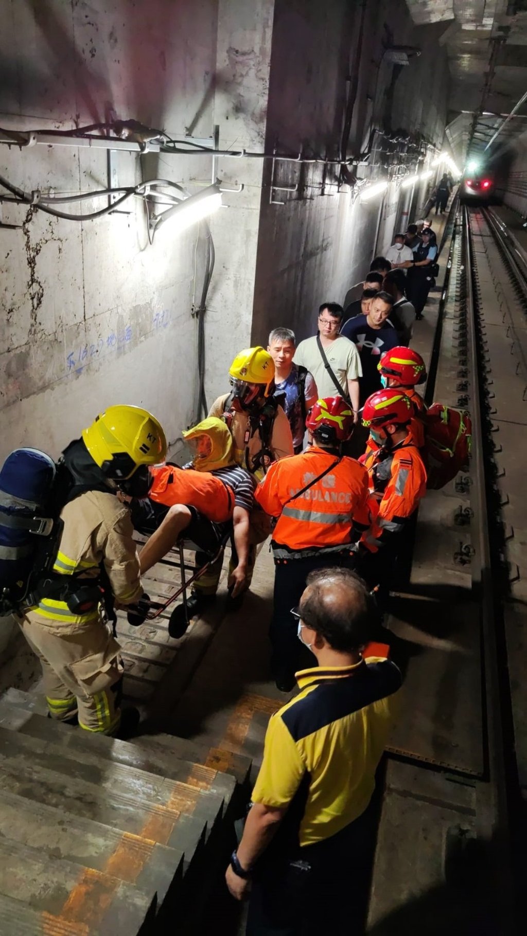 Drill participants simulate passenger evacuation via the rail tracks at Kai Tak station on the Tuen Ma line. Photo: Handout Drill participants simulate passenger evacuation via the rail tracks at Kai Tak station on the Tuen Ma line. Photo: Handout