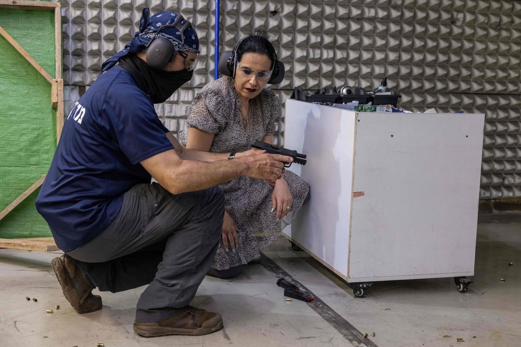 Limor Gonen is shown how to use a handgun at a shooting range in the Israeli settlement of Ariel in the West Bank in May. Photo: AFP Limor Gonen is shown how to use a handgun at a shooting range in the Israeli settlement of Ariel in the West Bank in May. Photo: AFP