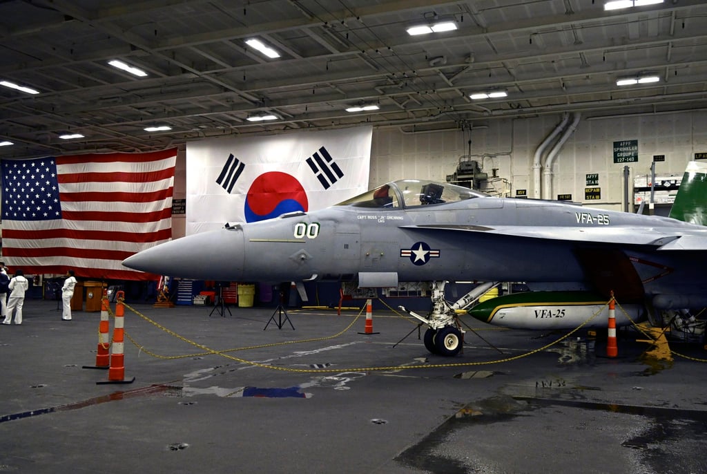 An F-18 fighter aircraft sits in the hangar of the USS Theodore Roosevelt nuclear-powered aircraft carrier, anchored in Busan Naval Base, Busan, South Korea, on Saturday. Photo: EPA-EFE