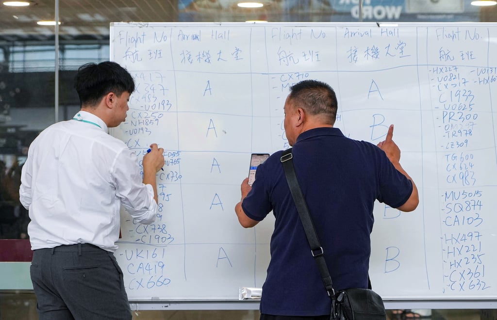 Flight detail are being written on whiteboards. Photo: Elson Li Flight detail are being written on whiteboards. Photo: Elson Li