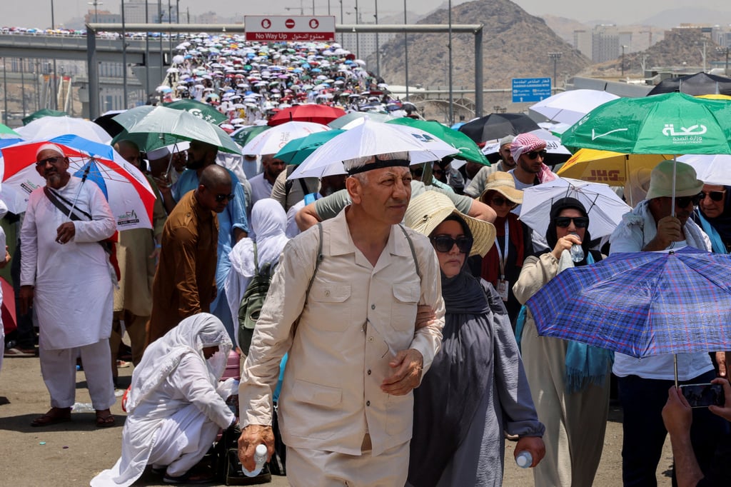 Muslim pilgrims use umbrellas to help shield themselves from the sun. Photo: Reuters
