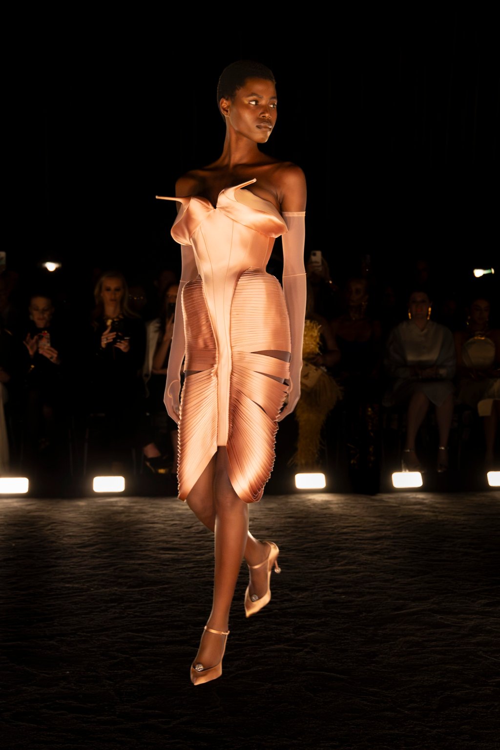 A look from the Schiaparelli haute couture autumn/winter 2024-25 show in Paris. It features a pair of vintage shoes inserted at the neckline A look from the Schiaparelli haute couture autumn/winter 2024-25 show in Paris. It features a pair of vintage shoes inserted at the neckline