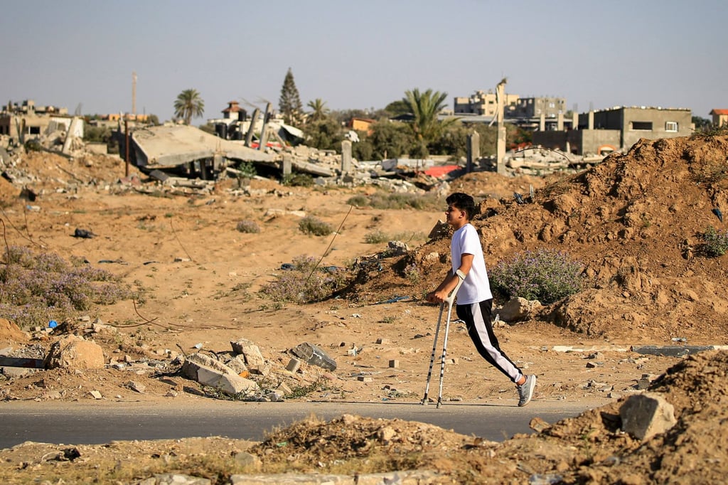 An amputee makes his way along a road at al-Bureij refugee camp in the central Gaza Strip. Photo: AFP