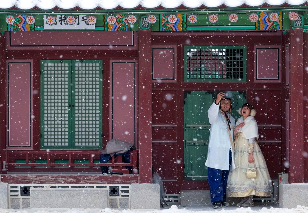 A couple wearing traditional “hanbok” outfits taking a selfie at the Gyeongbok Palace, in Seoul, South Korea. Photo: AP A couple wearing traditional “hanbok” outfits taking a selfie at the Gyeongbok Palace, in Seoul, South Korea. Photo: AP