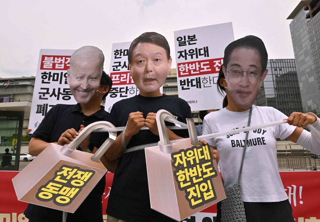South Korean protesters wearing masks depicting President Yoon Suk-yeol, US President Joe Biden and Japan’s Prime Minister Fumio Kishida during a protest against a trilateral military exercise in front of the US embassy in Seoul on Thursday. Photo: AFP South Korean protesters wearing masks depicting President Yoon Suk-yeol, US President Joe Biden and Japan’s Prime Minister Fumio Kishida during a protest against a trilateral military exercise in front of the US embassy in Seoul on Thursday. Photo: AFP