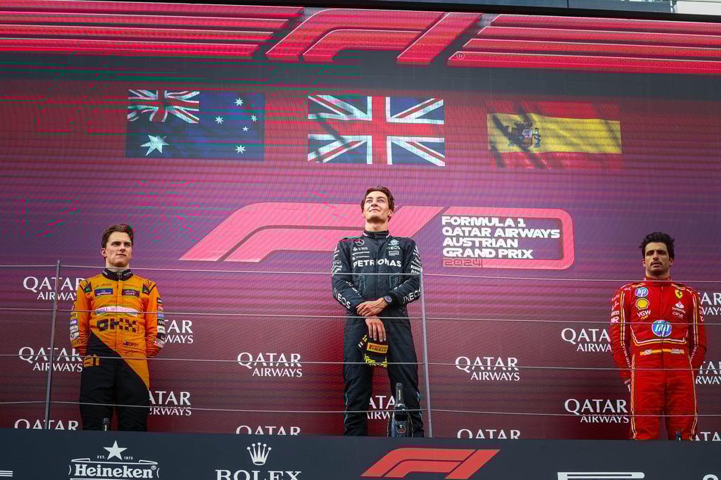 George Russell, centre, is all smiles on the podium after coming out on top in the Austrian GP. Photo: DPA