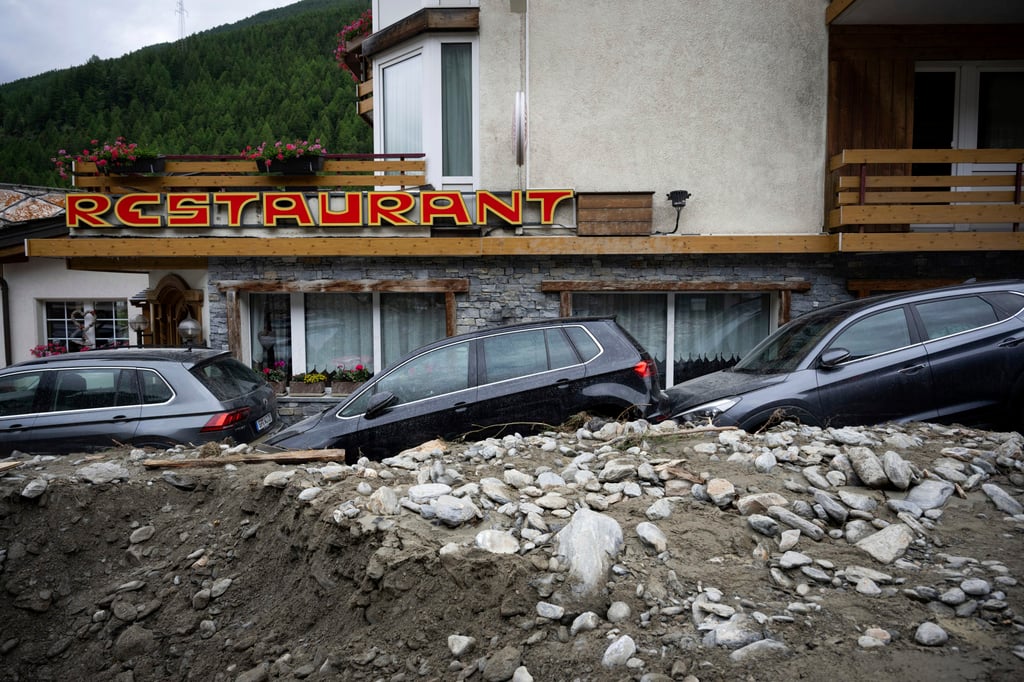 Cars stuck in the rubble from a landslide in Saas-Grund, Switzerland. Photo: Olivier Maire/Keystone via AP