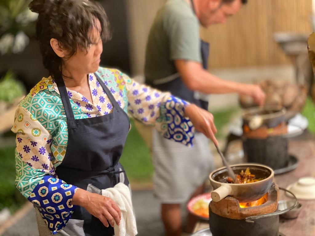 A guests at Jungle Kitchen cooks over a charcoal fire. Photo: Jungle Kitchen