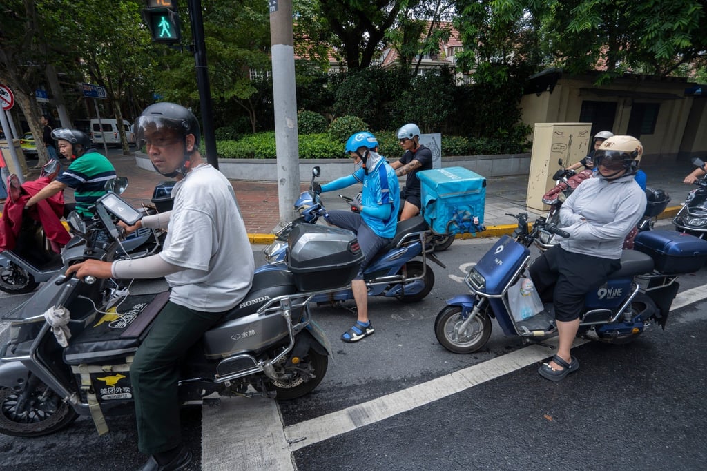 Meituan and Ele.me delivery workers seen waiting at a traffic light among other electric bike riders on the streets in Shanghai on August 9, 2023. Photo: Shutterstock Meituan and Ele.me delivery workers seen waiting at a traffic light among other electric bike riders on the streets in Shanghai on August 9, 2023. Photo: Shutterstock