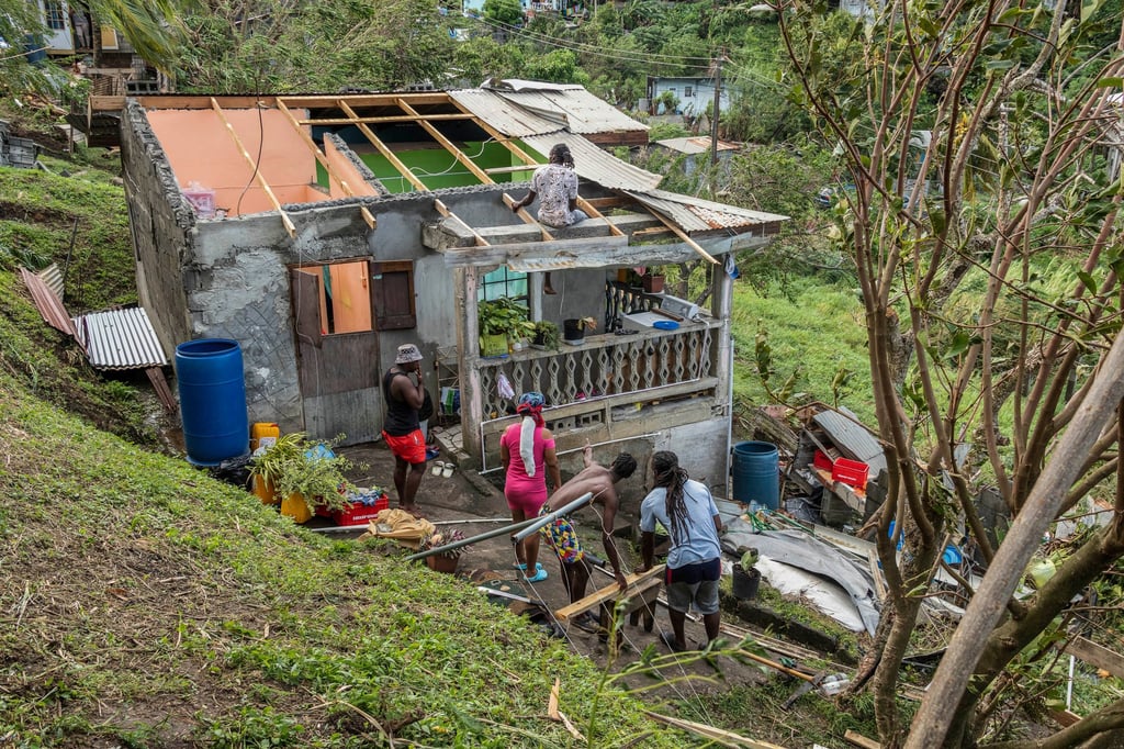 Family members begin to repair their home damaged by Hurricane Beryl in Ottley Hall, St Vincent and the Grenadines on Tuesday. Photo: AP Family members begin to repair their home damaged by Hurricane Beryl in Ottley Hall, St Vincent and the Grenadines on Tuesday. Photo: AP