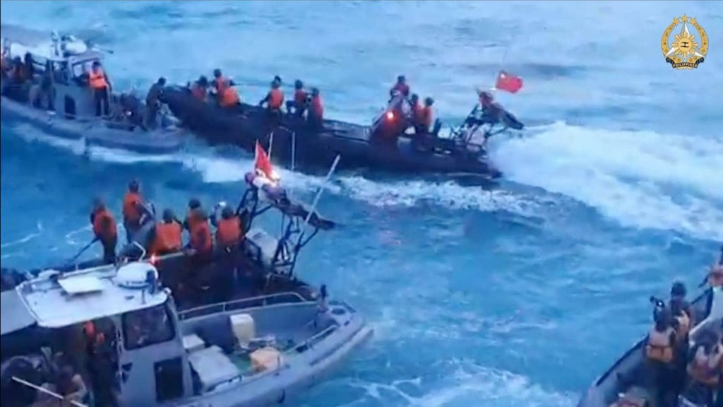 A video frame grab shows Chinese coastguard personnel aboard rigid hull inflatable boats (in black) during a confrontation with Philippine Navy personnel on their respective vessels (in grey) near the Second Thomas Shoal in disputed waters of the South China Sea on June 17. Photo: Handout / Armed Forces of the Philippines / AFP