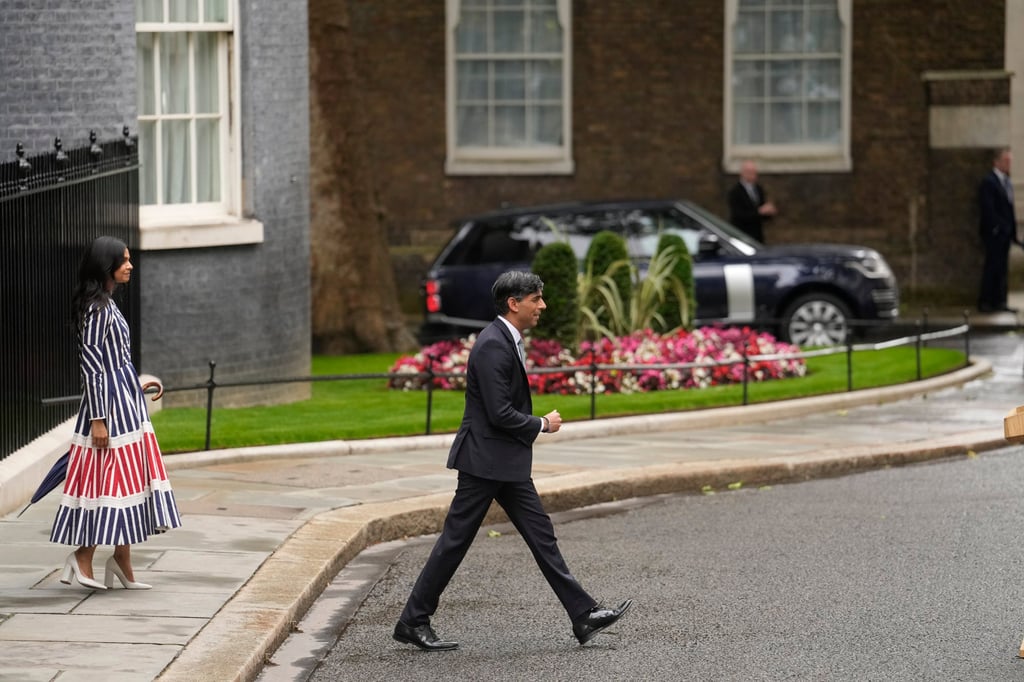 Britain’s outgoing Prime Minister Rishi Sunak with his wife Akshata Murty walk out of 10 Downing Street. Photo: AFP