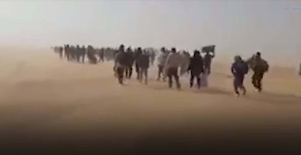 Migrants expelled from Algeria are forced to walk into the Sahara desert, in this screenshot from a video. File photo: AP/Ju Dennis