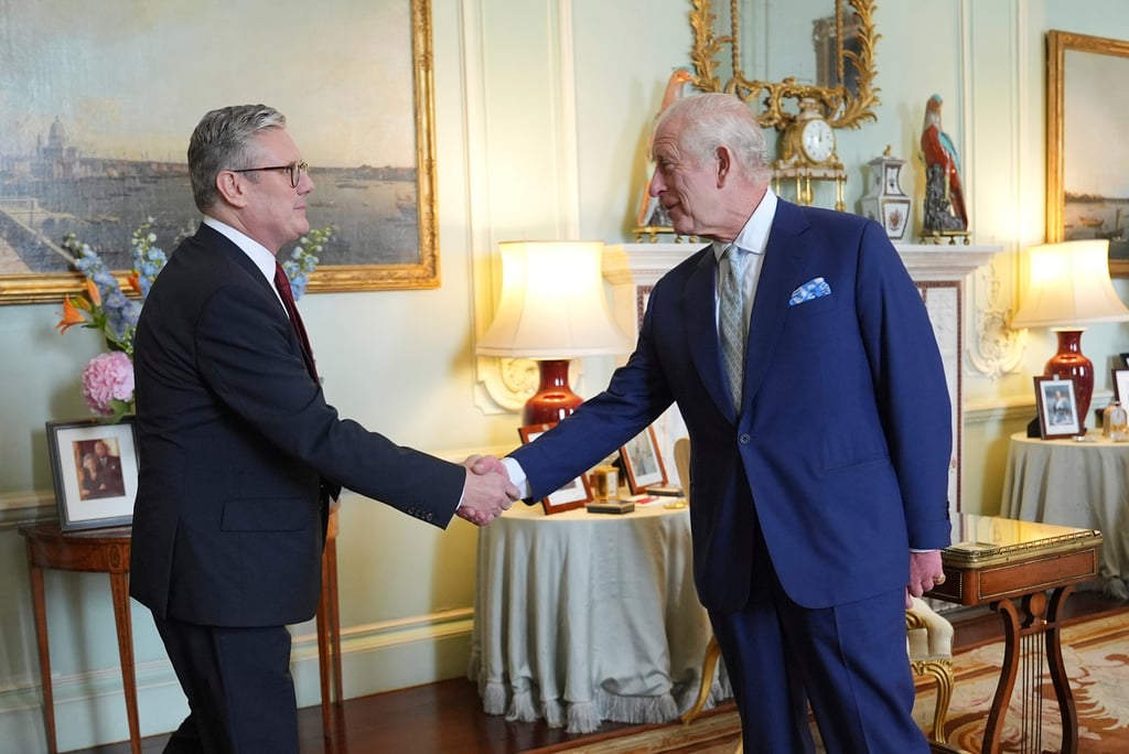 Britain’s King Charles III (right) shakes hands with Keir Starmer where he invited the Labour Party leader to become prime minister and to form a new government. Photo: AP