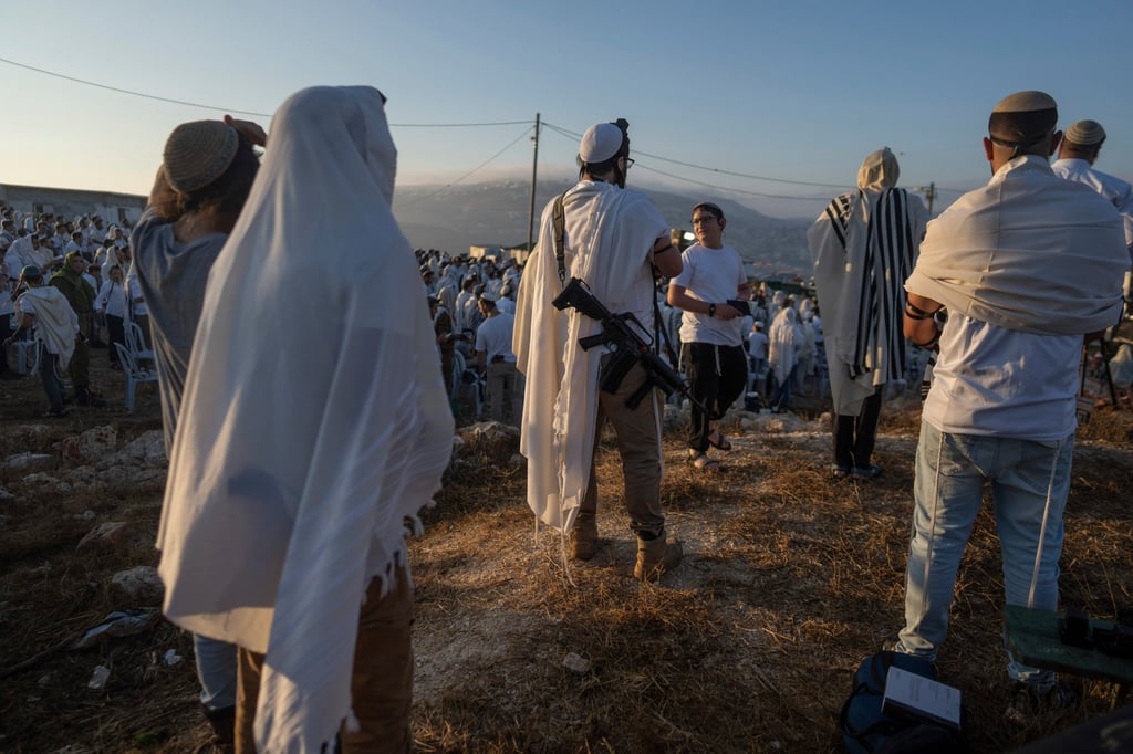 Jewish settlers pray in the Eviatar outpost in the Israeli-occupied West Bank during morning prayers calling for the legalisation of the outpost and the return of the hostages held in Gaza by Hamas. Photo: AP Jewish settlers pray in the Eviatar outpost in the Israeli-occupied West Bank during morning prayers calling for the legalisation of the outpost and the return of the hostages held in Gaza by Hamas. Photo: AP